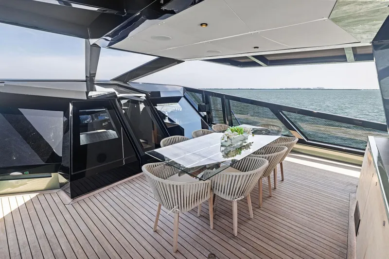 Slide: The Image of Luxurious 2023 Wally WHY 150 yacht with elegant outdoor dining area and ocean view. - 14