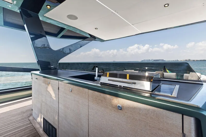 Slide: The Image of Luxury yacht Wally WHY 150, 2023 model, featuring a sleek outdoor kitchen with ocean view. - 17
