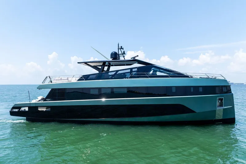 Slide: The Image of Luxury yacht Wally WHY 150, 2023 model, cruising on open water under a clear sky. - 2