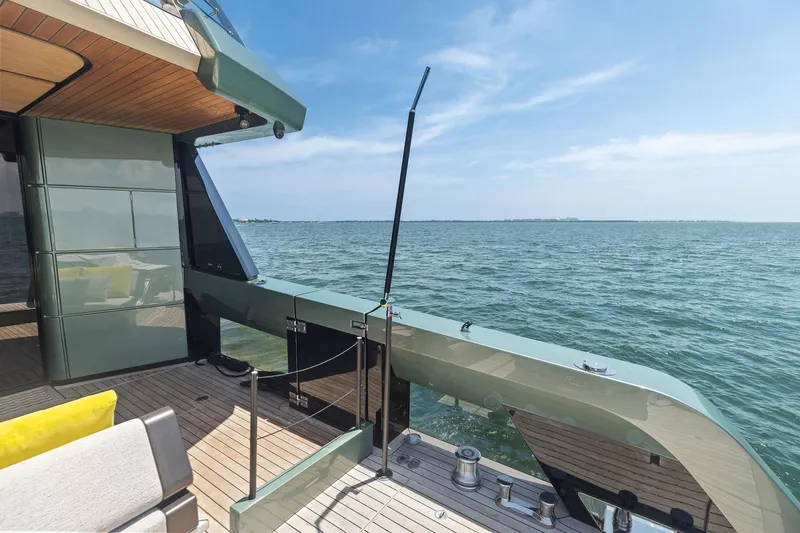 Slide: The Image of Luxury yacht Wally WHY 150, 2023 model, with sleek deck overlooking serene ocean. - 22