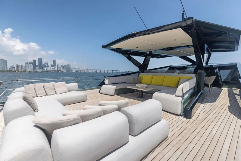 Slide: The Image of Luxurious 2023 Wally WHY 150 yacht deck with modern seating and city skyline view. - 32