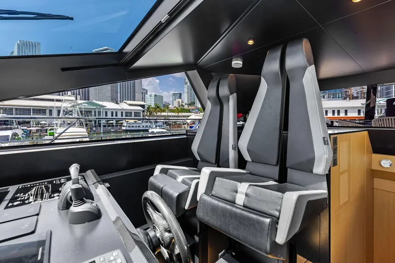 Slide: The Image of Interior of 2023 Wally WHY 150 yacht with modern cockpit and cityscape view. - 36