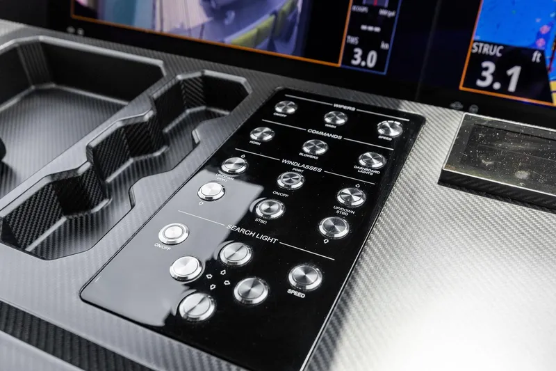 Slide: The Image of Control panel of 2023 Wally WHY 150 yacht with carbon fiber finish and various buttons. - 39