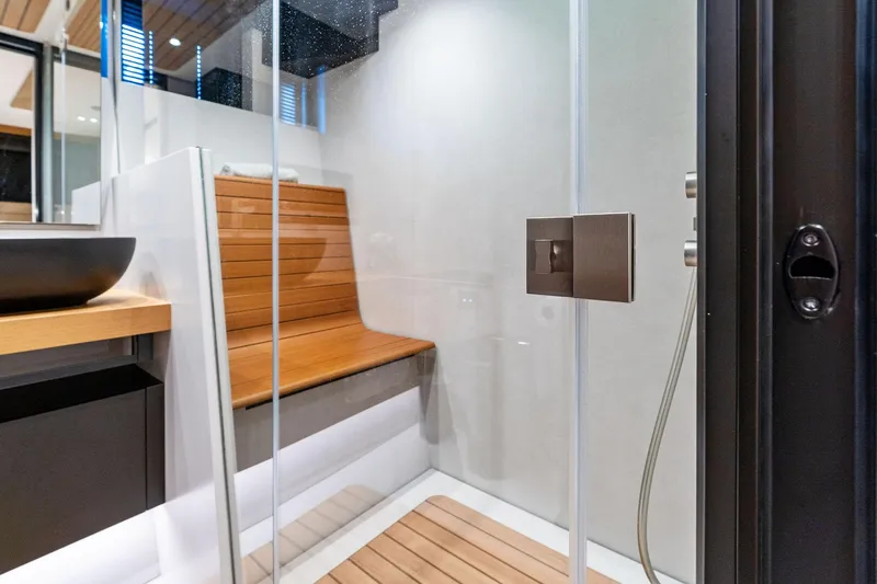 Slide: The Image of Modern yacht bathroom with wooden bench, glass shower, and sleek fixtures on Wally WHY 150, 2023. - 73