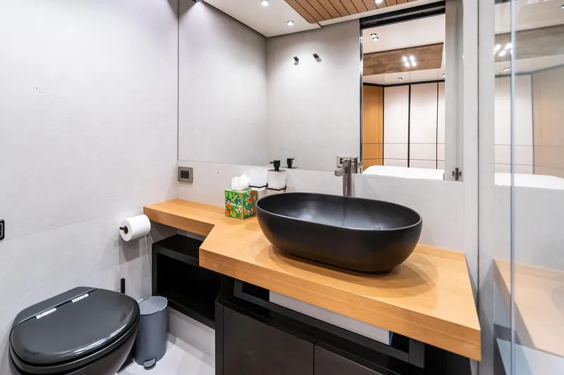 Slide: The Image of Modern bathroom on 2023 Wally WHY 150 yacht with sleek black fixtures and wooden accents. - 77