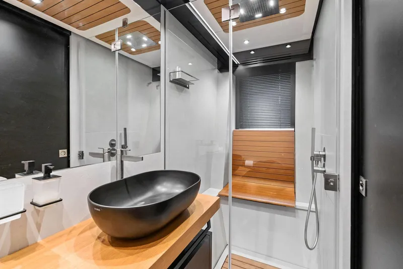 Slide: The Image of Modern bathroom in 2023 Wally WHY 150 yacht with sleek black sink and wooden accents. - 78