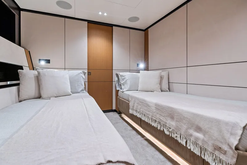 Slide: The Image of Luxurious twin cabin interior of 2023 Wally WHY 150 yacht, featuring modern design and cozy bedding. - 82