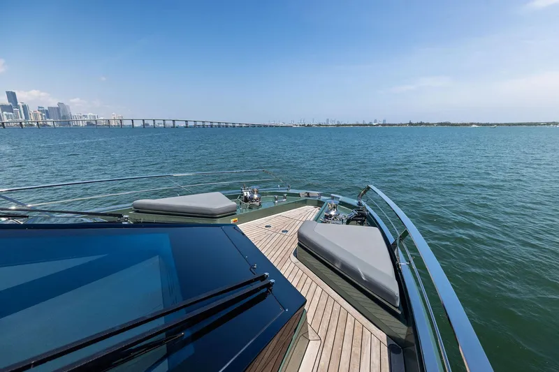 Slide: The Image of Luxury yacht Wally WHY 150, 2023 model, cruising near a city skyline and bridge. - 9