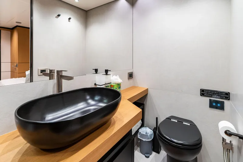 Slide: The Image of Modern bathroom on 2023 Wally WHY 150 yacht with sleek black fixtures and wooden countertop. - 98
