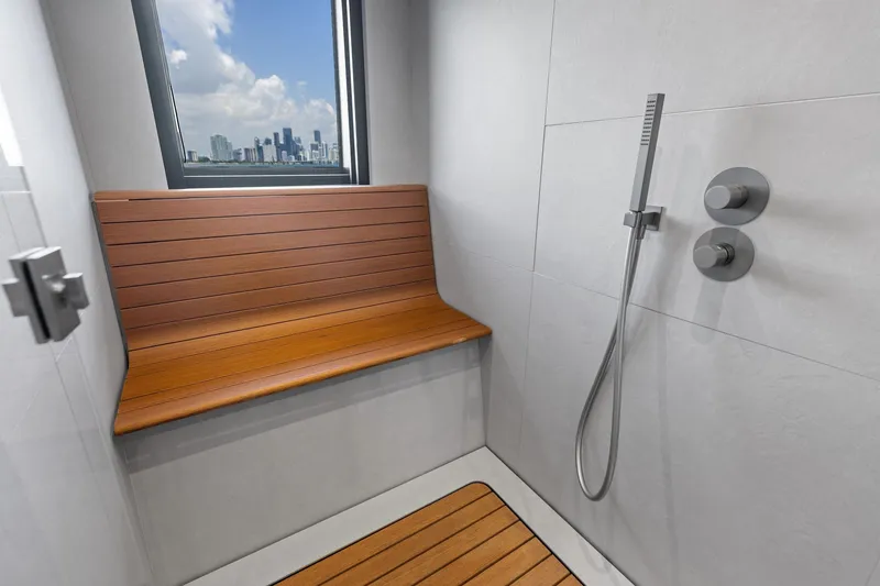 Slide: The Image of Modern shower with wooden bench and city view on Wally WHY 150 yacht, 2023 model. - 99