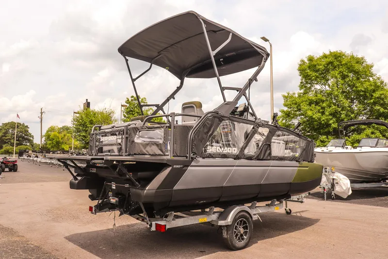 Slide: The Image of 2025 Sea-Doo Switch Fish 18-230 HP pontoon boat on trailer, parked outdoors. - 3