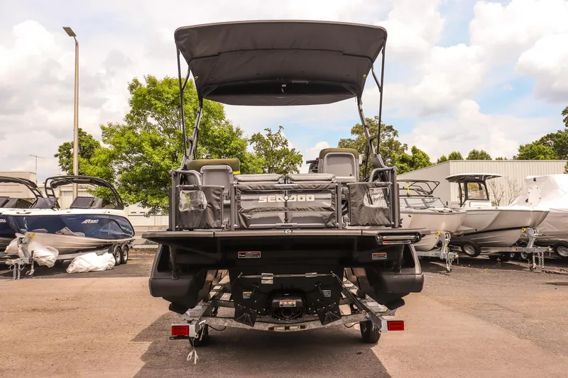 Slide: The Image of 2025 Sea-Doo Switch Fish 18-230 HP boat, rear view, parked outdoors. - 4