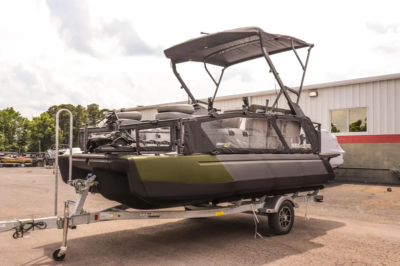 Slide: The Image of 2025 Sea-Doo Switch Fish 18-230 HP on trailer, parked outdoors near a building. - 7
