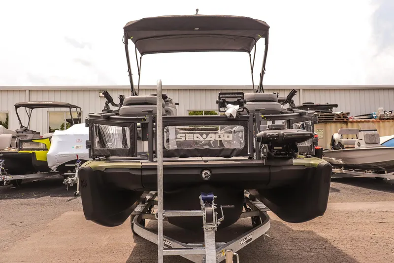 Slide: The Image of 2025 Sea-Doo Switch Fish 18-230 HP pontoon boat on trailer, outdoor display. - 8