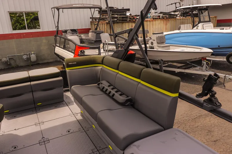 Slide: The Image of 2025 Sea-Doo Switch Fish 18-230 HP pontoon boat interior with seating and fishing rod holders. - 9