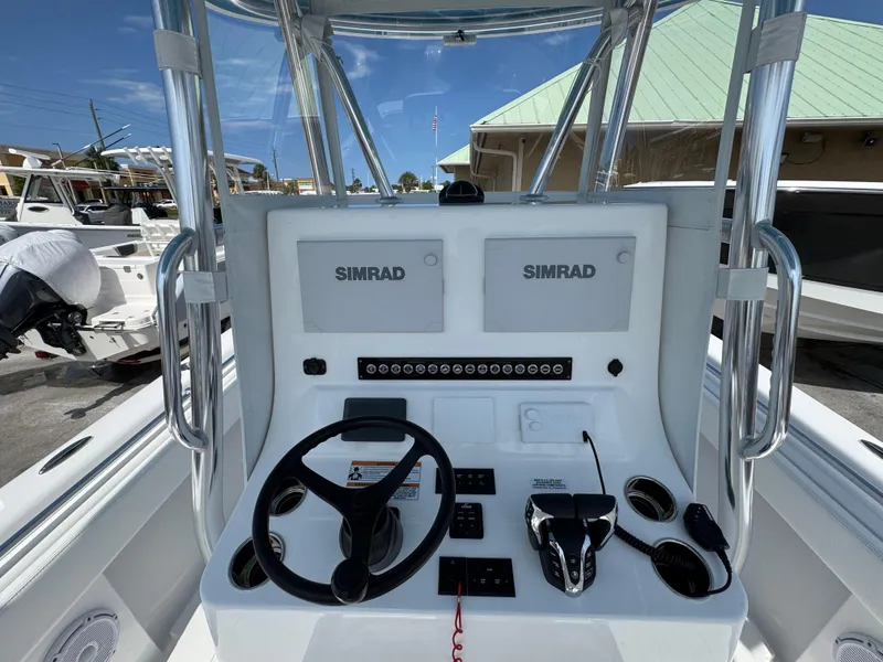 Slide: The Image of 2024 Contender 28 Tournament boat console with Simrad electronics and steering wheel. - 10