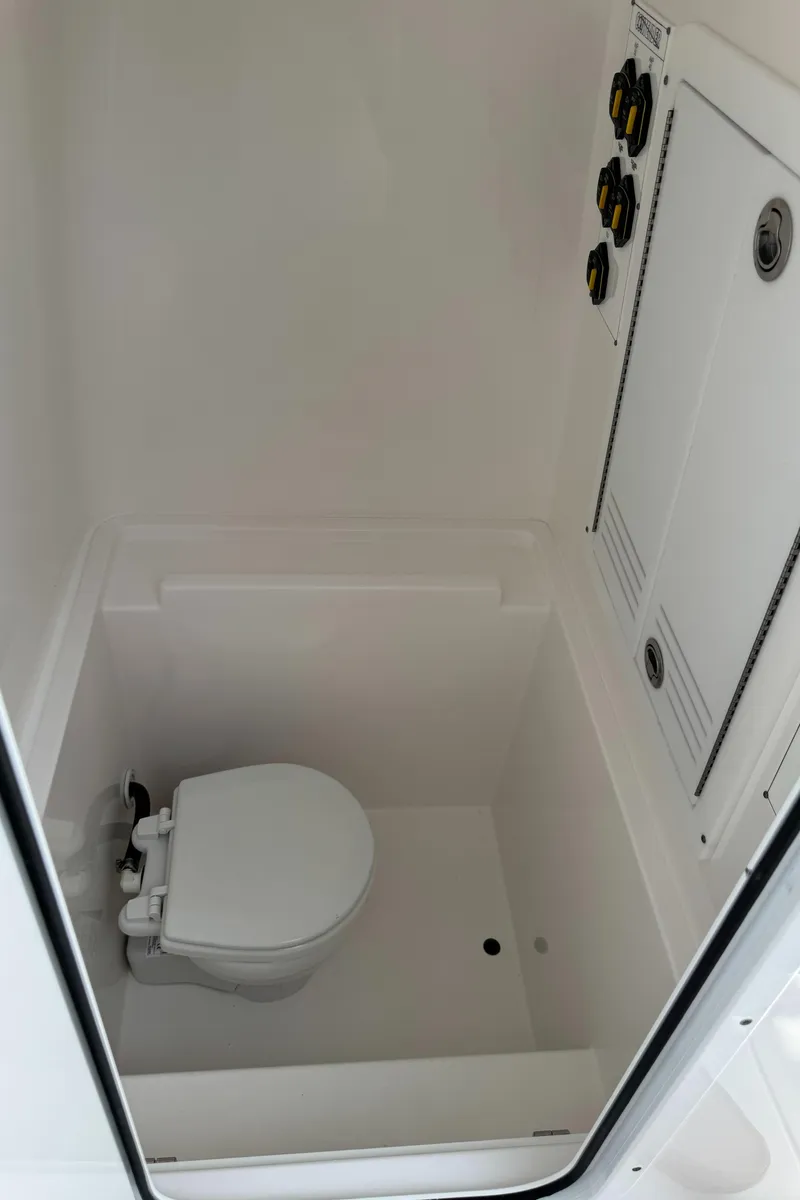 Slide: The Image of 2024 Contender 28 Tournament boat interior with compact marine toilet. - 11
