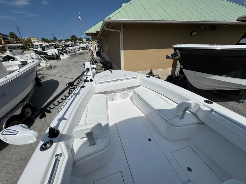 Slide: The Image of 2024 Contender 28 Tournament boat with spacious seating, docked at a marina under clear skies. - 14