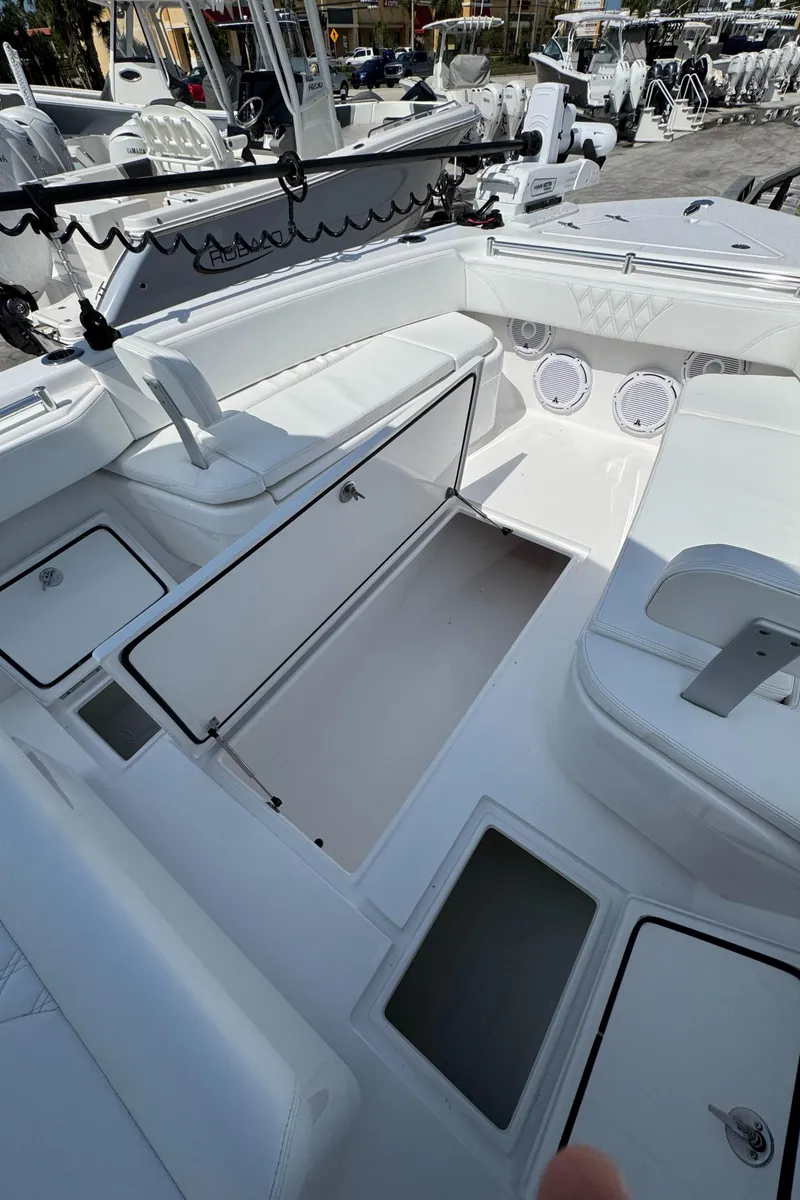 Slide: The Image of 2024 Contender 28 Tournament boat interior with open storage compartments and seating. - 17