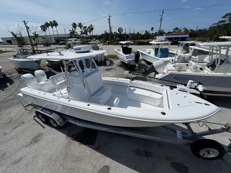 Slide: The Image of 2024 Contender 28 Tournament boat on trailer, parked in a marina lot. - 4