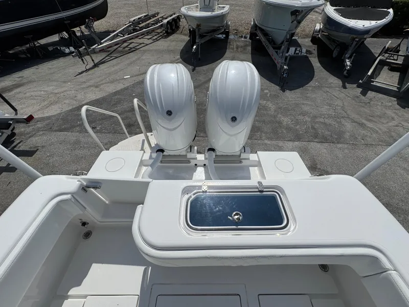 Slide: The Image of 2024 Contender 28 Tournament boat with dual outboard engines, docked on a trailer. - 7
