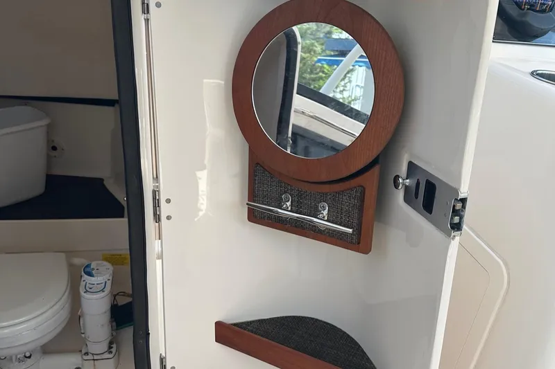 Slide: The Image of 2016 Grady-White Freedom 285 boat interior with mirror and toilet. - 14
