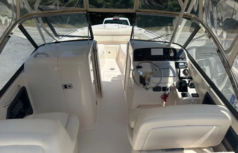 Slide: The Image of 2016 Grady-White Freedom 285 boat interior with steering console and seating. - 3