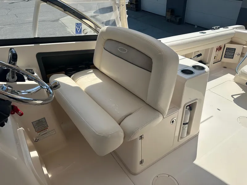 Slide: The Image of 2016 Grady-White Freedom 285 boat interior with steering wheel and seating area. - 4