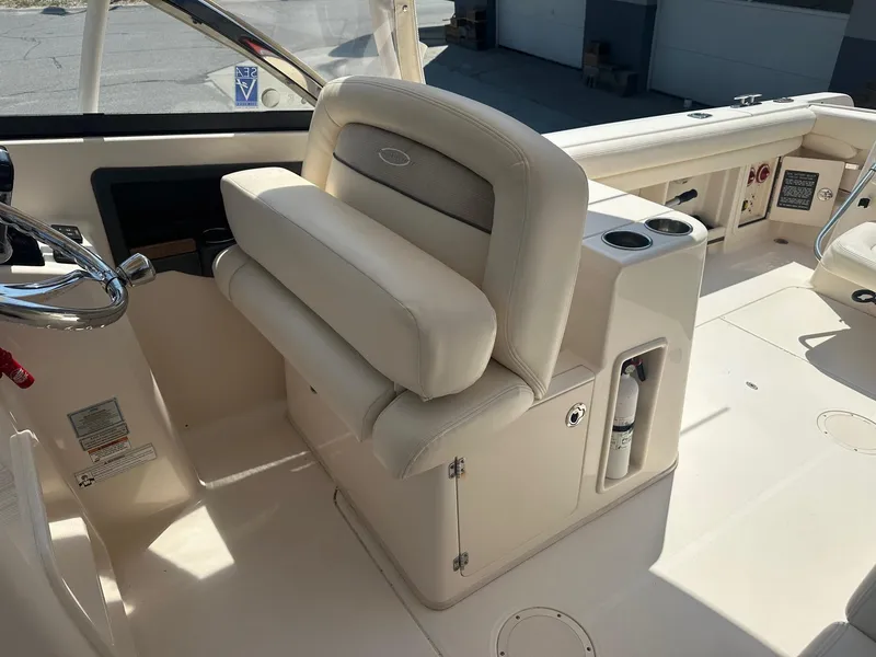 Slide: The Image of 2016 Grady-White Freedom 285 boat interior with helm seat and steering wheel. - 5