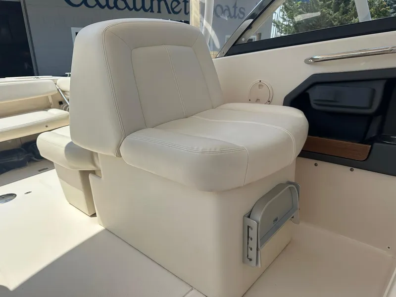 Slide: The Image of 2016 Grady-White Freedom 285 boat interior with beige seating and storage compartment. - 6