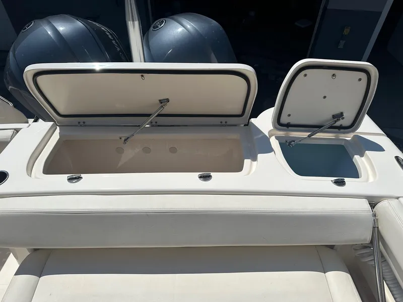 Slide: The Image of 2016 Grady-White Freedom 285 boat with open storage compartments and dual engines. - 9