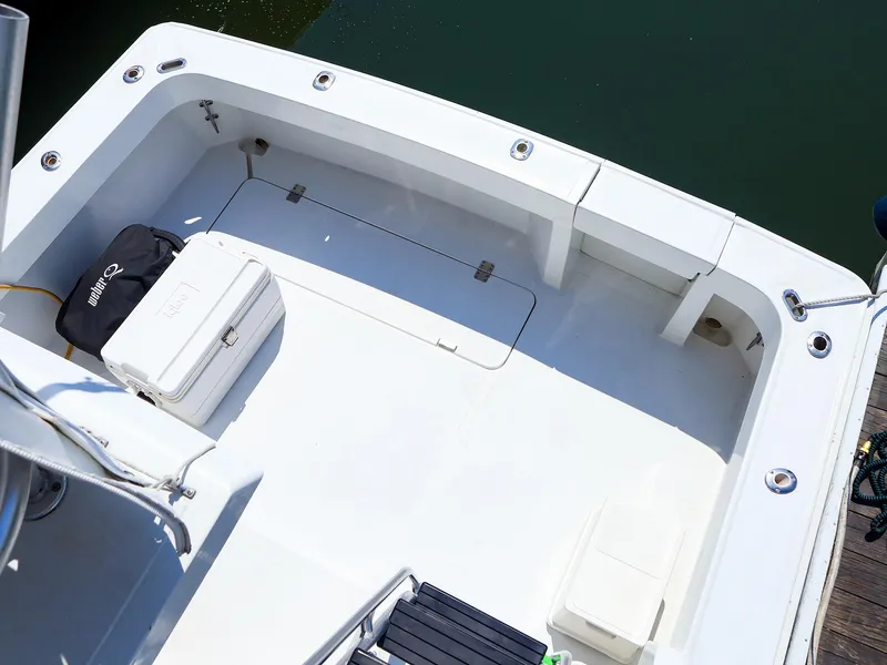 Slide: The Image of 1997 Luhrs 32 Convertible boat deck with cooler and storage compartments. - 11