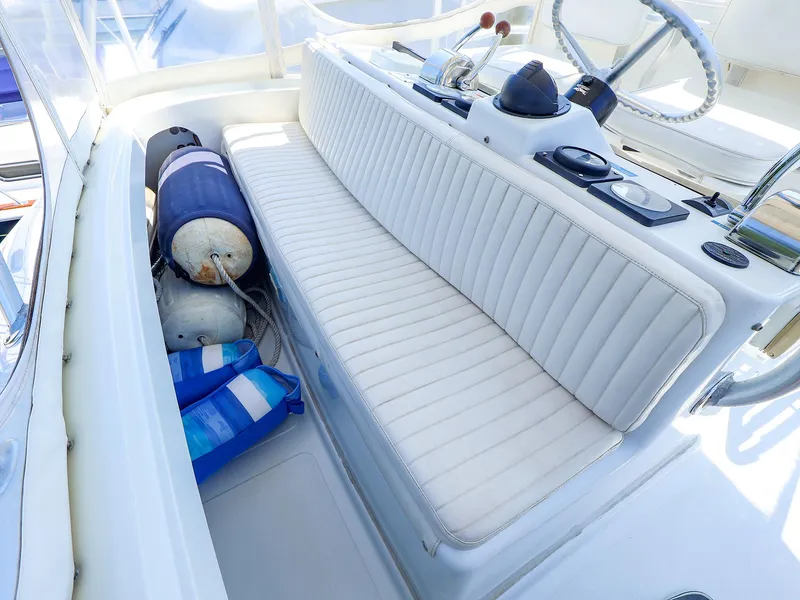 Slide: The Image of 1997 Luhrs 32 Convertible boat cockpit with white seating and nautical equipment. - 13