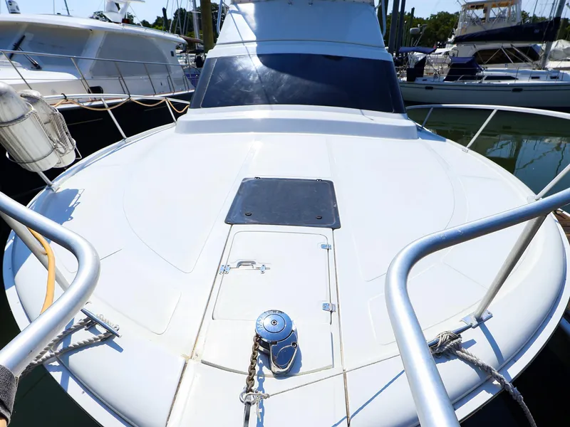 Slide: The Image of 1997 Luhrs 32 Convertible yacht bow view in marina setting. - 15