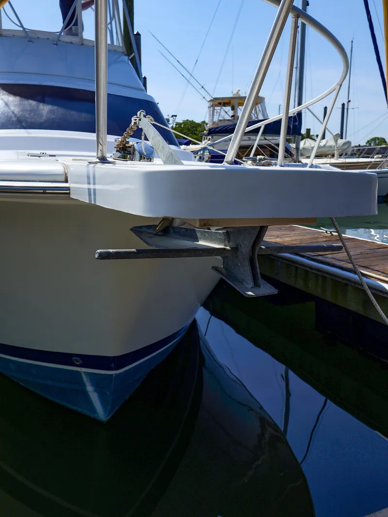 Slide: The Image of 1997 Luhrs 32 Convertible boat with anchor at marina dock. - 16