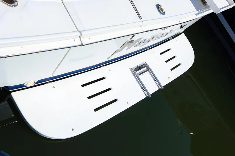 Slide: The Image of 1997 Luhrs 32 Convertible swim platform with ladder, docked on calm water. - 21