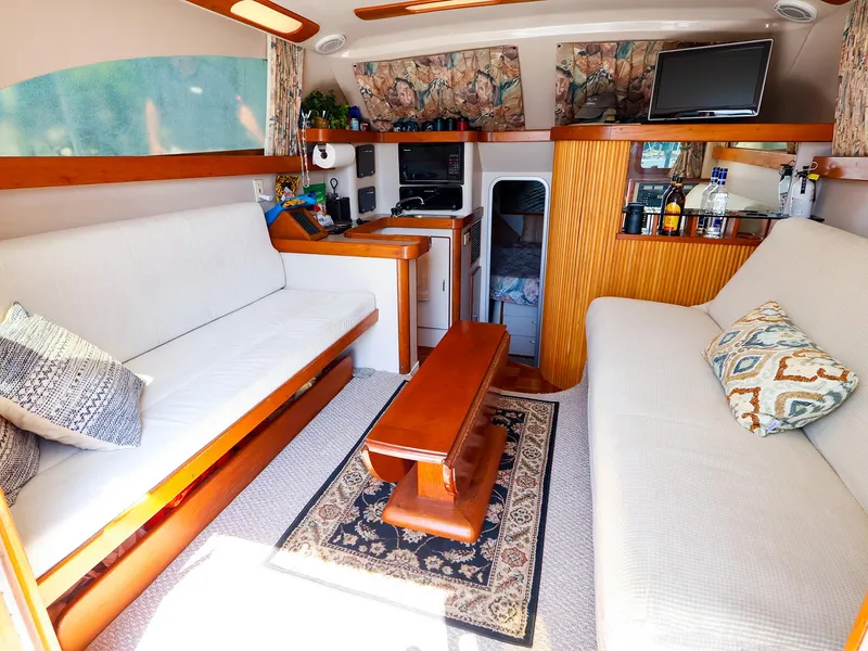 Slide: The Image of Interior of 1997 Luhrs 32 Convertible yacht with cozy seating and modern amenities. - 24