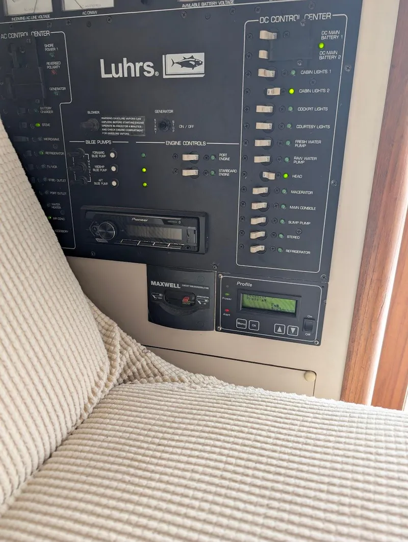Slide: The Image of Control panel of a 1997 Luhrs 32 Convertible boat with various switches and displays. - 27