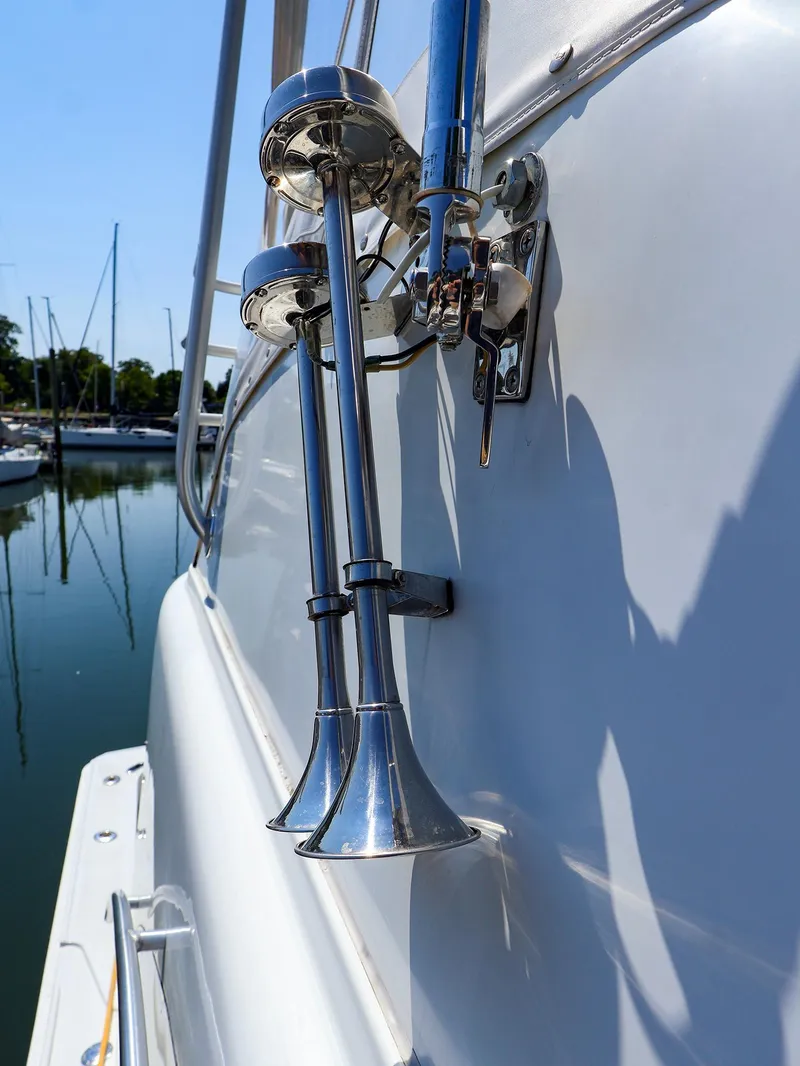 Slide: The Image of Close-up of 1997 Luhrs 32 Convertible boat's chrome horn detail in marina setting. - 6