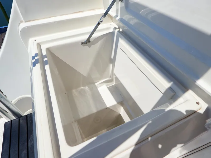 Slide: The Image of Open storage compartment on 1997 Luhrs 32 Convertible boat, featuring white interior. - 8
