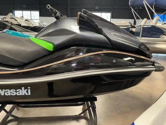 Slide: The Image of 2019 Kawasaki Ultra LX jet ski in showroom, black with green accents. - 10
