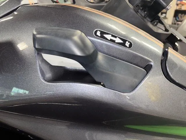 Slide: The Image of 2019 Kawasaki Ultra LX handle adjustment lever on a sleek, dark body. - 14