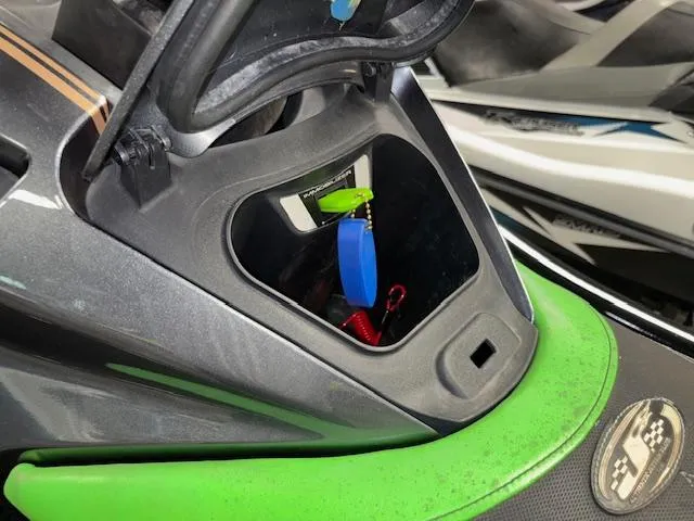 Slide: The Image of 2019 Kawasaki Ultra LX storage compartment with colorful key fobs inside. - 15