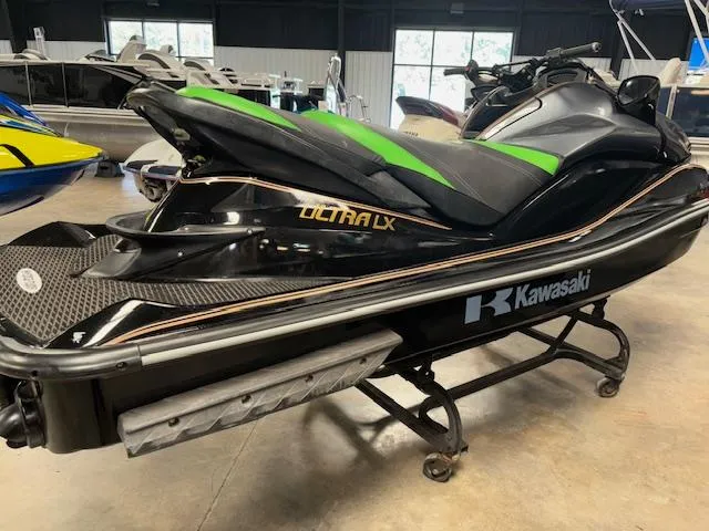 Slide: The Image of 2019 Kawasaki Ultra LX jet ski in showroom, black and green design. - 8