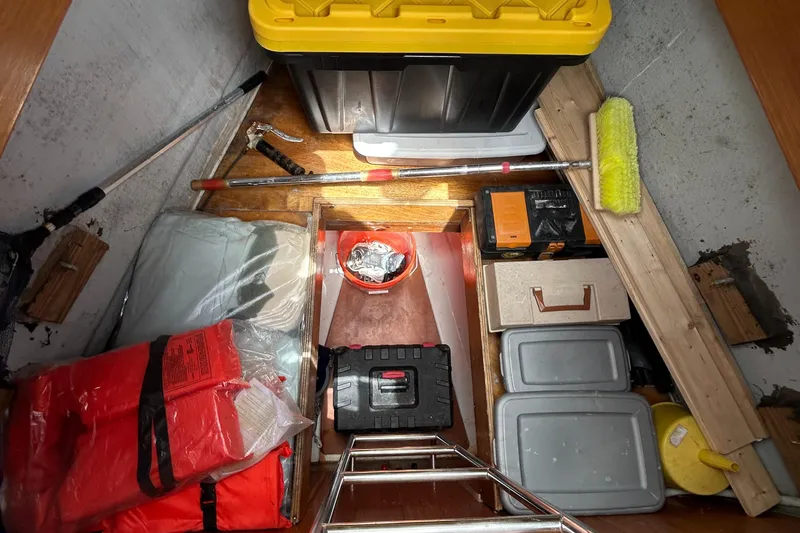 Slide: The Image of Storage compartment on a 2007 Beneteau Cyclades 50.3 yacht, featuring tools and safety gear. - 12
