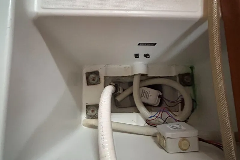 Slide: The Image of Beneteau Cyclades 50.3 2007 yacht interior showing plumbing and wiring components. - 14