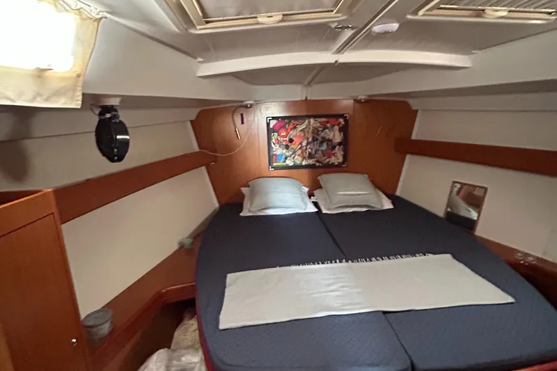 Slide: The Image of Cozy cabin interior of 2007 Beneteau Cyclades 50.3 sailboat with double bed and artwork. - 16