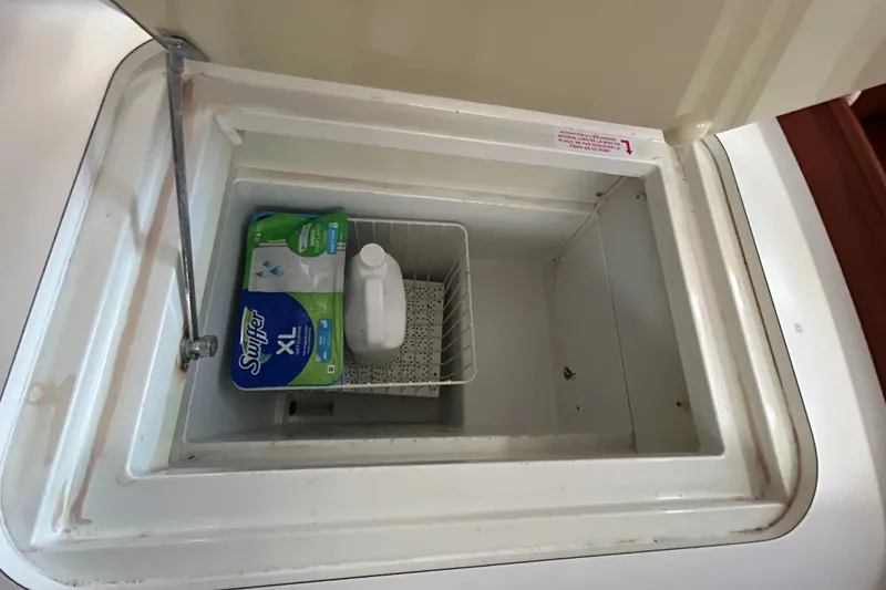 Slide: The Image of Storage compartment on 2007 Beneteau Cyclades 50.3 yacht with cleaning supplies inside. - 18