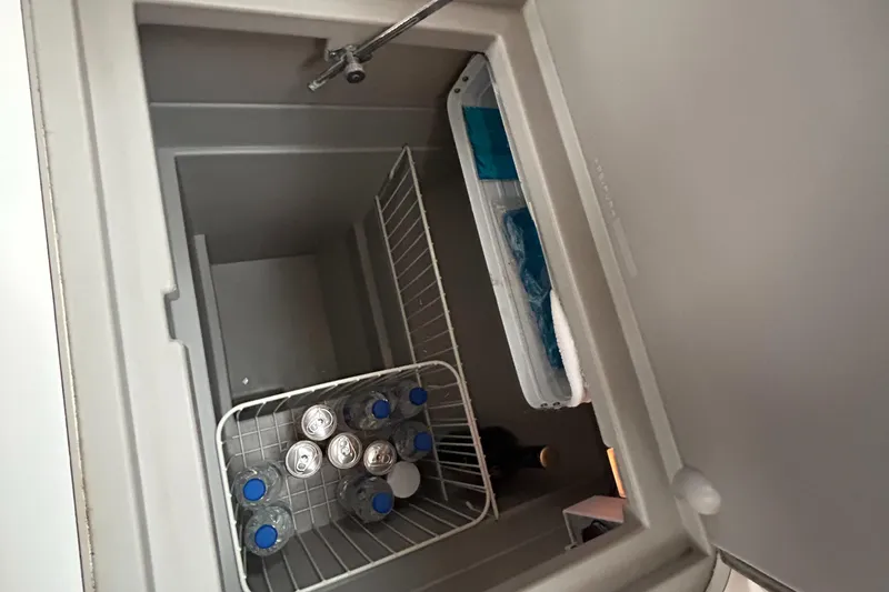 Slide: The Image of Open fridge on Beneteau Cyclades 50.3 yacht, stocked with drinks and ice packs. - 19
