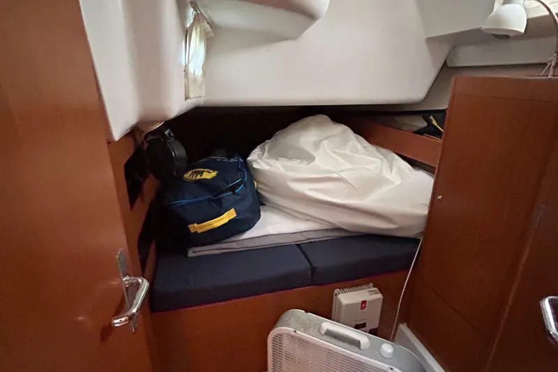 Slide: The Image of Cozy cabin interior of 2007 Beneteau Cyclades 50.3 sailboat with storage and bedding. - 22